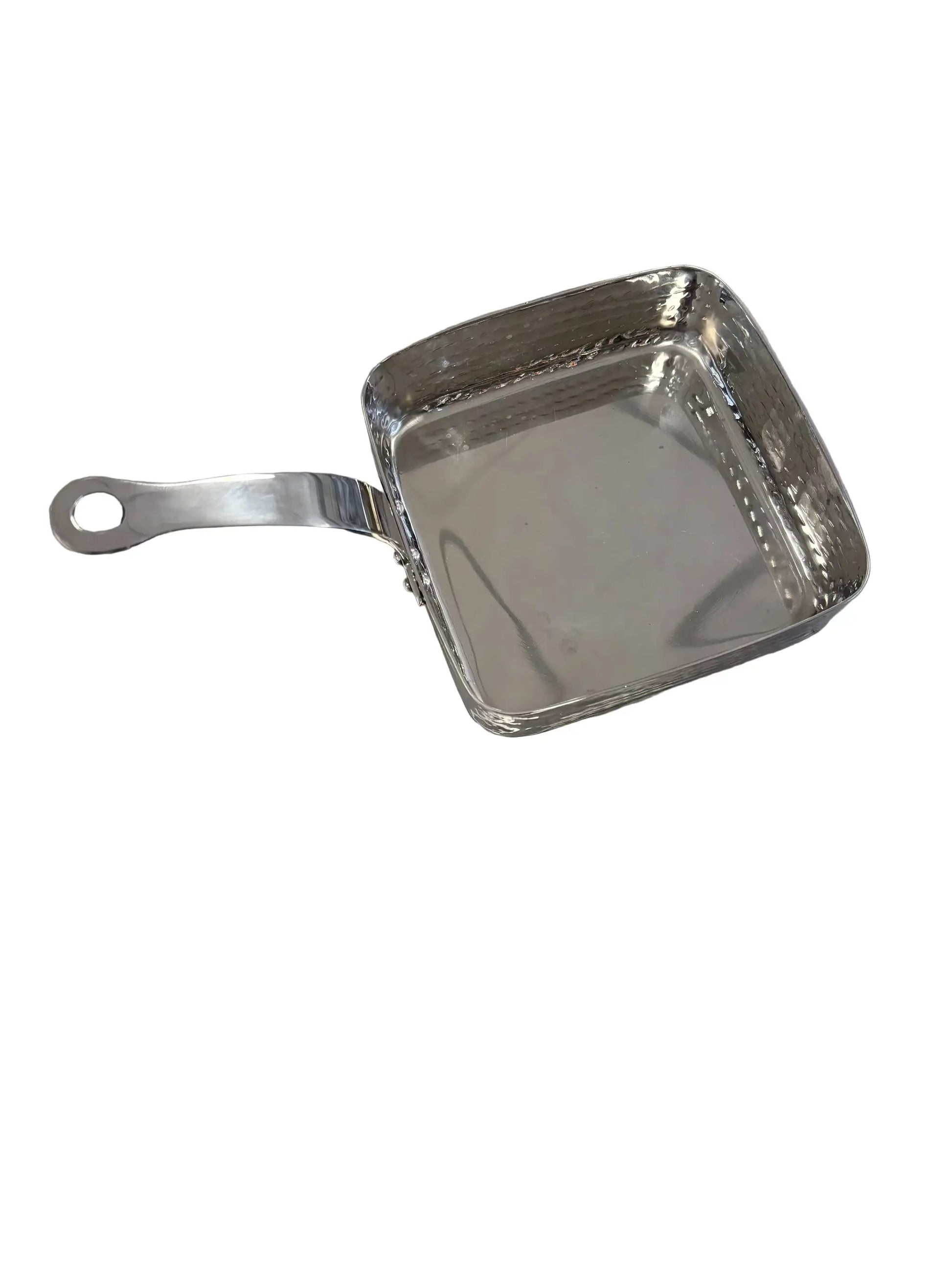 Metallic square frying pan on a reflective surface